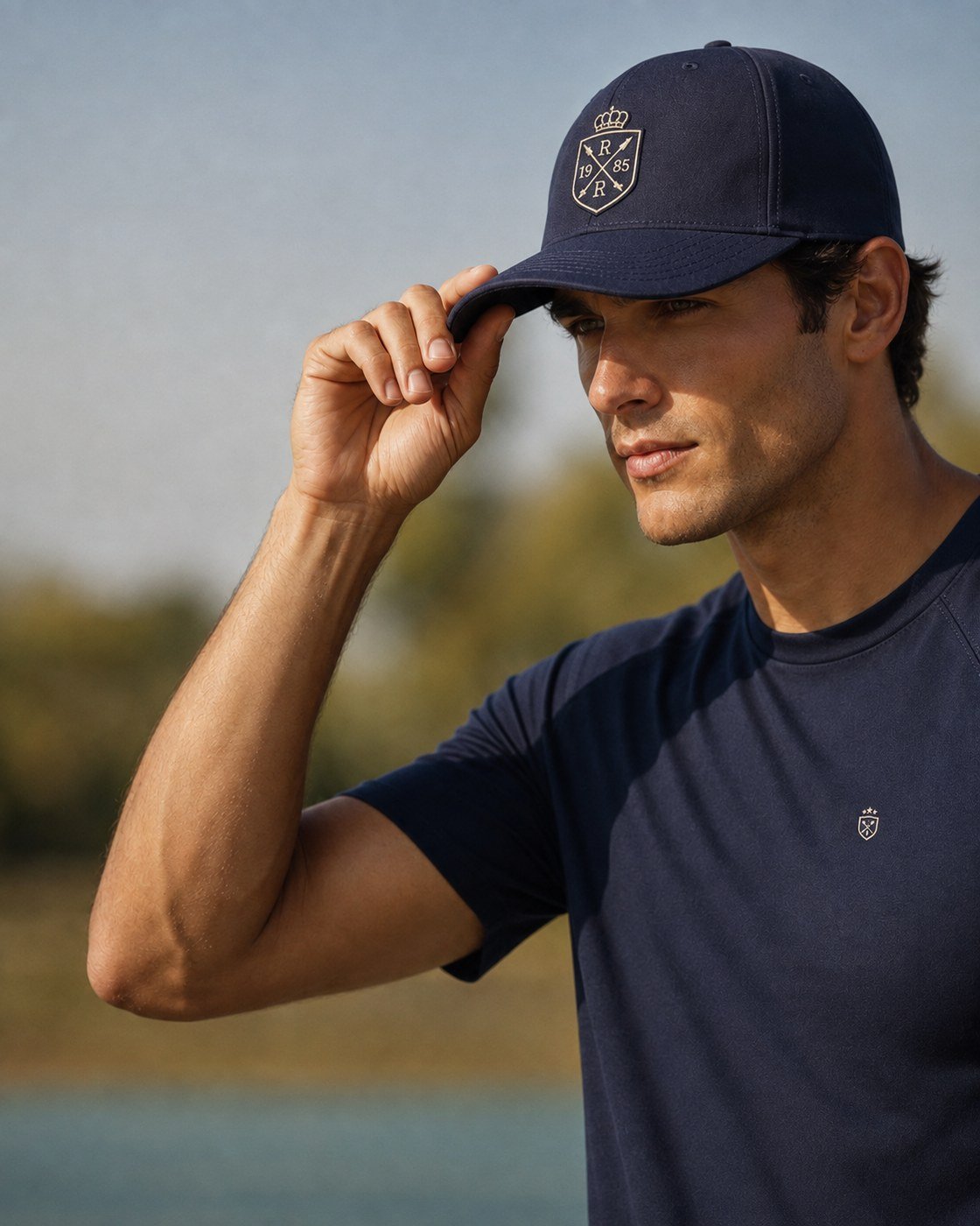 Athlete adjusting a navy branded cap outdoors