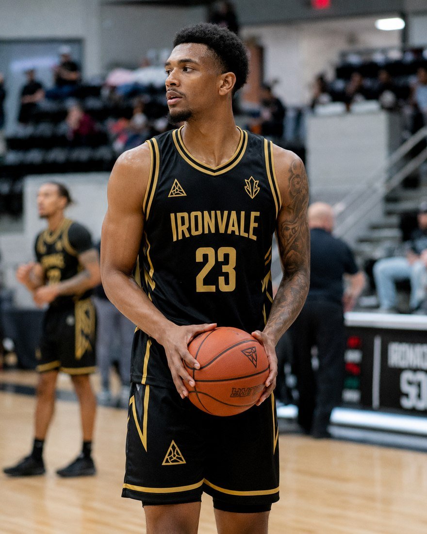 Basketball player at the free-throw line in a black and gold jersey